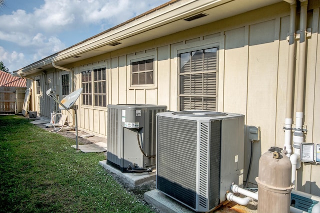 details featuring fence, pump, and central AC