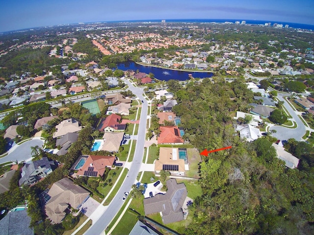 birds eye view of property with a water view and a residential view