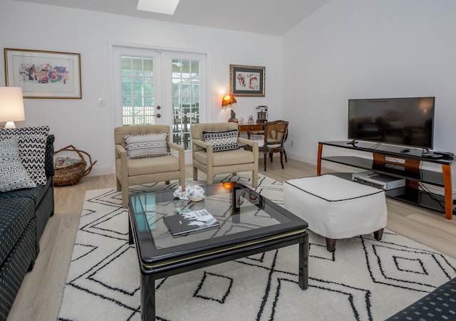 living room with baseboards, french doors, and wood finished floors