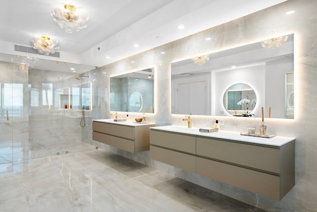 bathroom featuring tiled shower and vanity