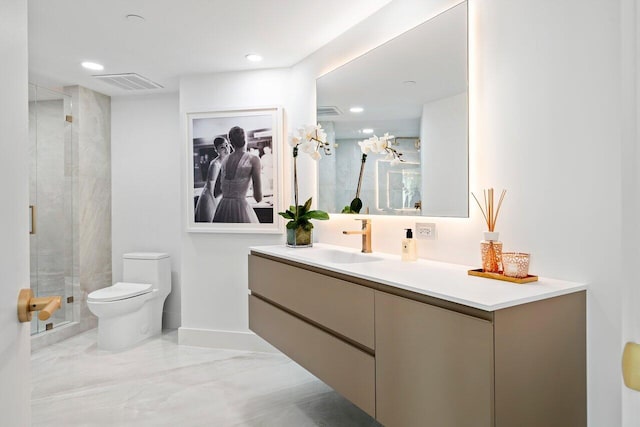 bathroom with vanity, toilet, and a shower with shower door