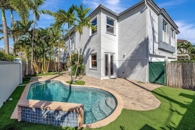 view of swimming pool featuring a yard, a patio area, a fenced backyard, and a fenced in pool