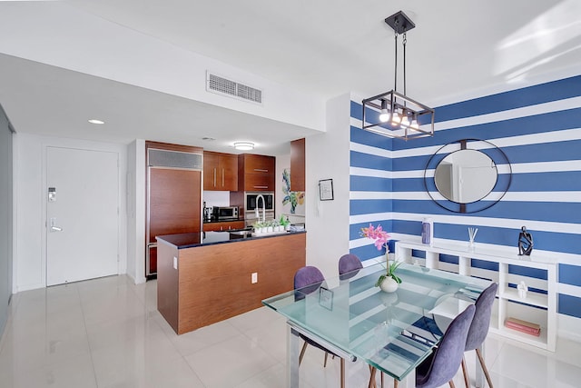 tiled dining room with a chandelier