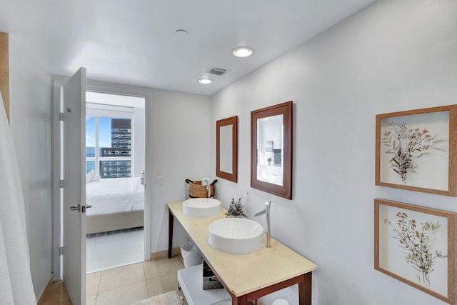 bathroom with tile patterned floors and vanity