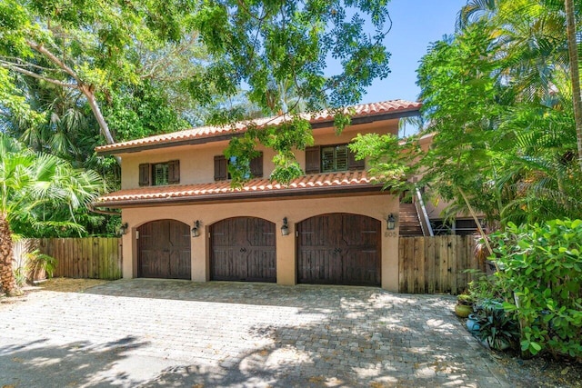 mediterranean / spanish home with a garage