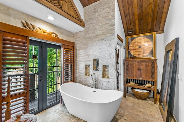 bathroom featuring wood ceiling, a tub to relax in, and high vaulted ceiling