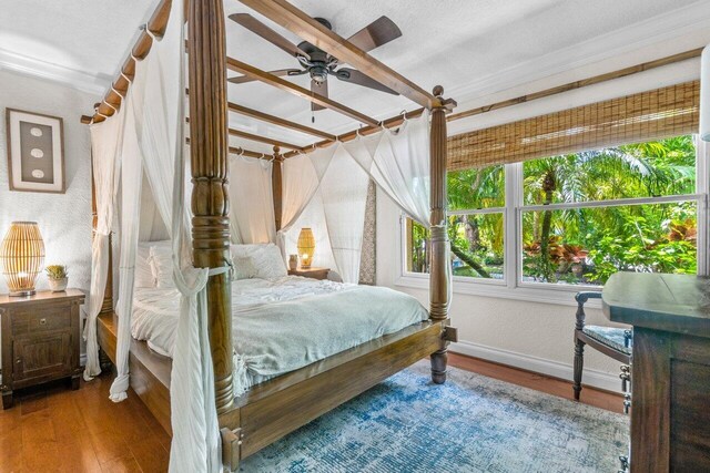 bedroom with ceiling fan and hardwood / wood-style floors