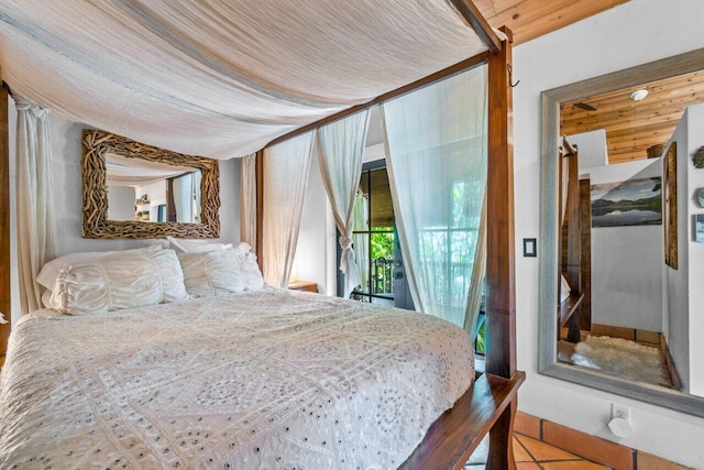 tiled bedroom with access to outside and wooden ceiling