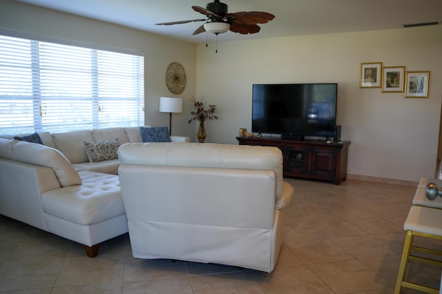 tiled living room with ceiling fan