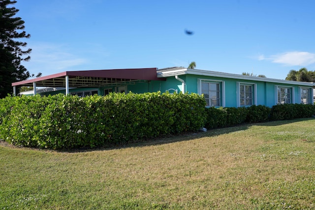 view of side of home featuring a lawn