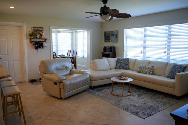 tiled living room with ceiling fan