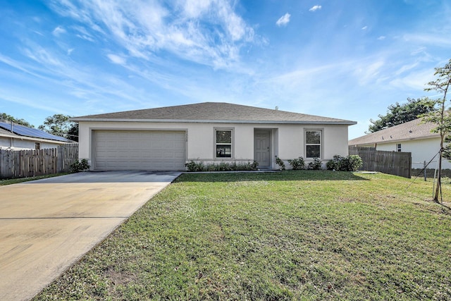 view of front of house with a front yard and a garage