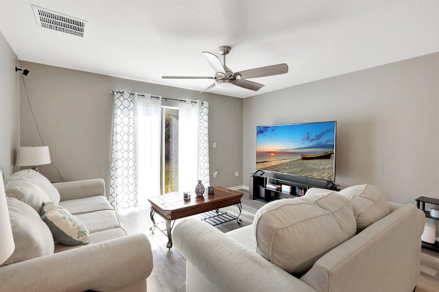 living room with ceiling fan and light hardwood / wood-style floors