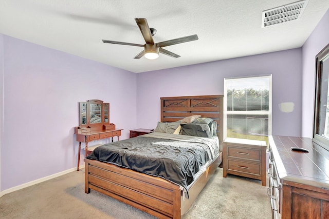 bedroom with ceiling fan and light colored carpet