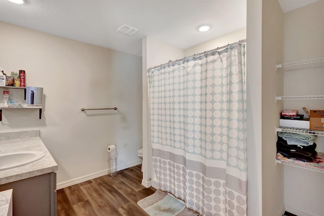 bathroom with hardwood / wood-style flooring, vanity, toilet, and a shower with shower curtain