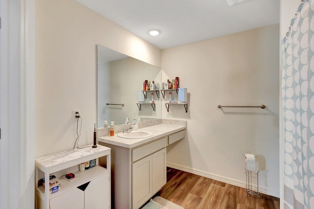 bathroom with vanity and hardwood / wood-style flooring