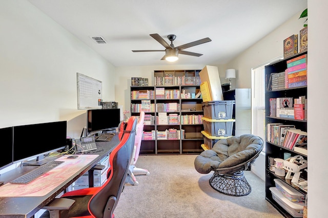 carpeted office featuring ceiling fan