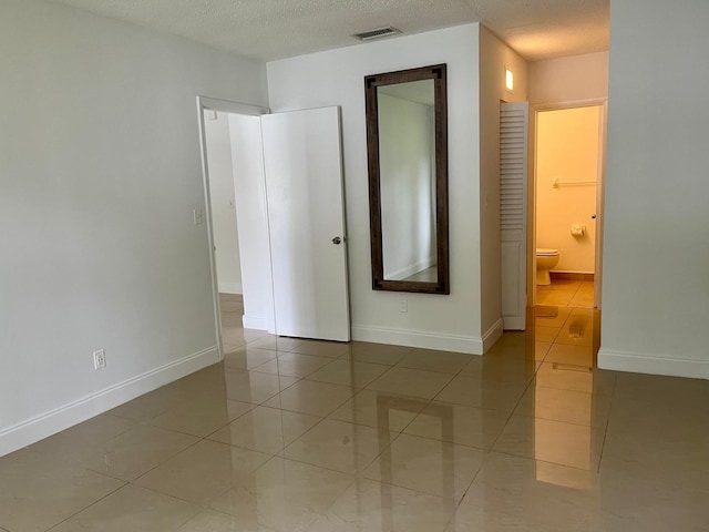 empty room with light tile patterned floors