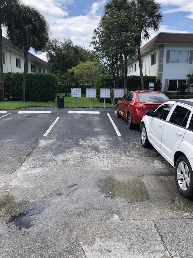 view of vehicle parking with mail boxes