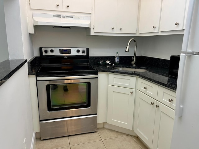 kitchen featuring dark stone counters, stainless steel electric stove, sink, range hood, and light tile patterned flooring