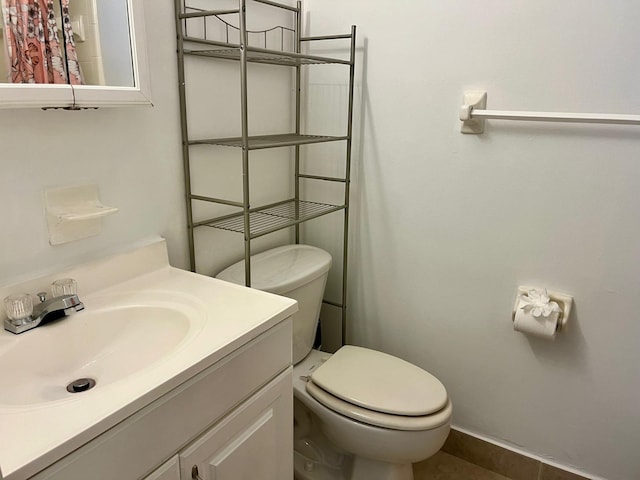 bathroom with tile patterned floors, vanity, and toilet