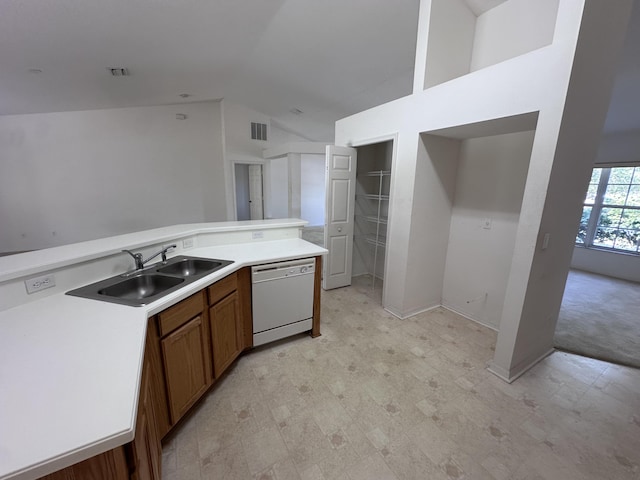 kitchen featuring sink, white dishwasher, and vaulted ceiling