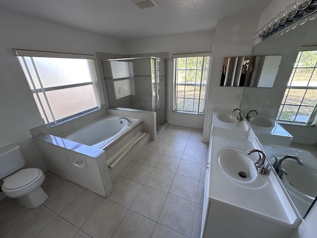 full bathroom with vanity, tile patterned floors, toilet, shower with separate bathtub, and a textured ceiling