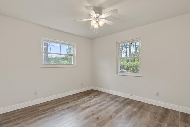 spare room with hardwood / wood-style floors and ceiling fan