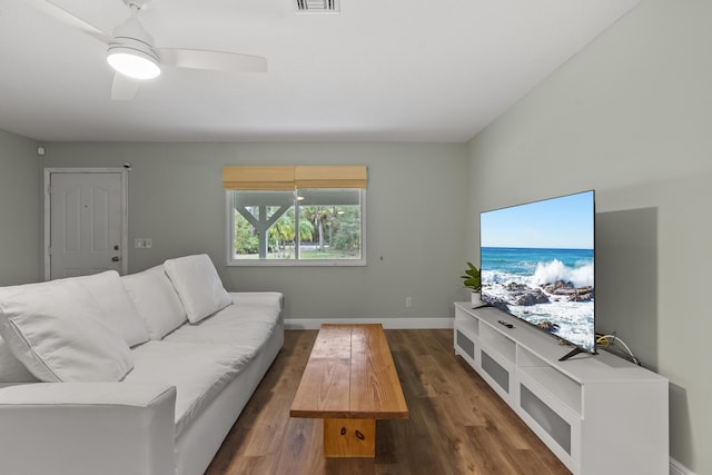 living room with ceiling fan and dark hardwood / wood-style flooring