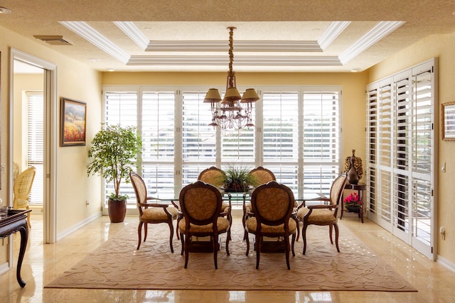 dining room with a tray ceiling, a chandelier, and ornamental molding