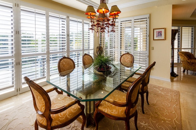 dining area featuring crown molding, light tile patterned flooring, and an inviting chandelier