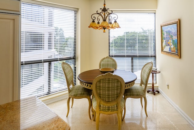 dining area featuring a chandelier and plenty of natural light