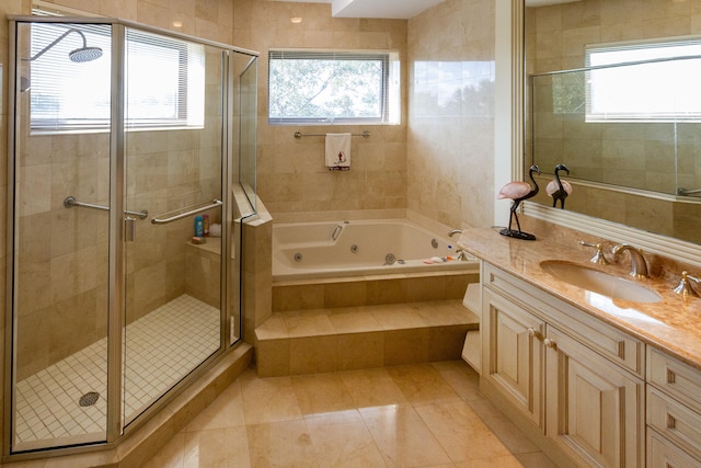 bathroom with tile patterned flooring, vanity, and plus walk in shower