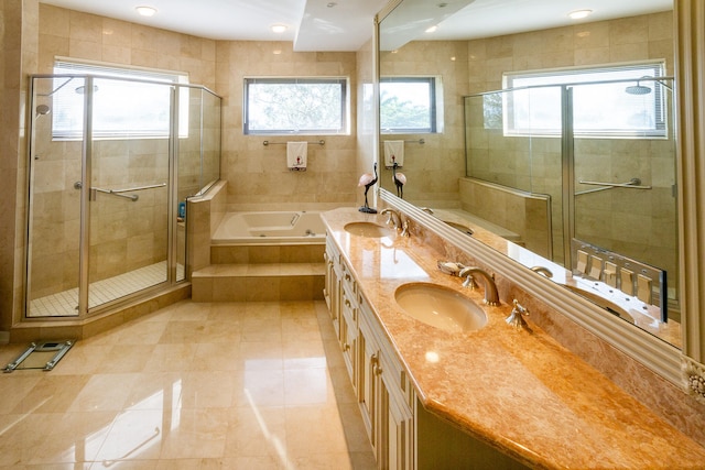 bathroom with plus walk in shower, vanity, and tile patterned floors