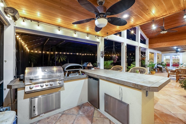 view of patio / terrace featuring an outdoor bar and a grill