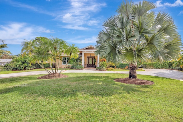 view of front of house with french doors and a front lawn