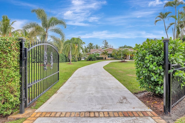 view of gate featuring a lawn