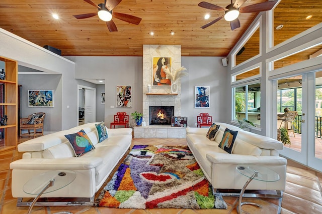 living room with ceiling fan, wood ceiling, a fireplace, and high vaulted ceiling