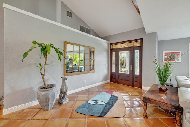 tiled foyer entrance featuring vaulted ceiling