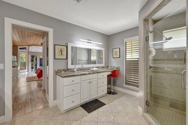 bathroom with tile patterned floors, plenty of natural light, and vanity