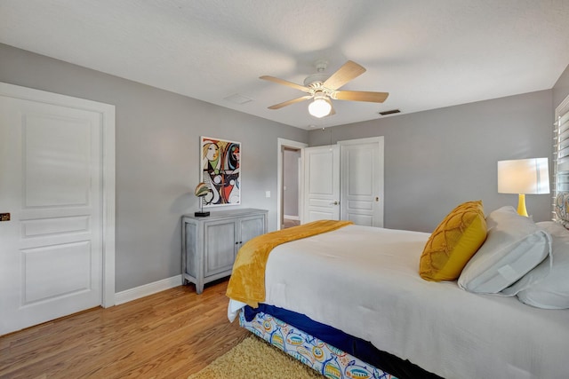 bedroom featuring light wood-type flooring, a closet, and ceiling fan