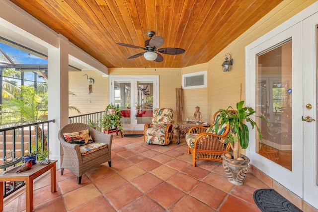 sunroom / solarium with ceiling fan and wooden ceiling