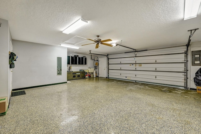 garage featuring electric panel and ceiling fan