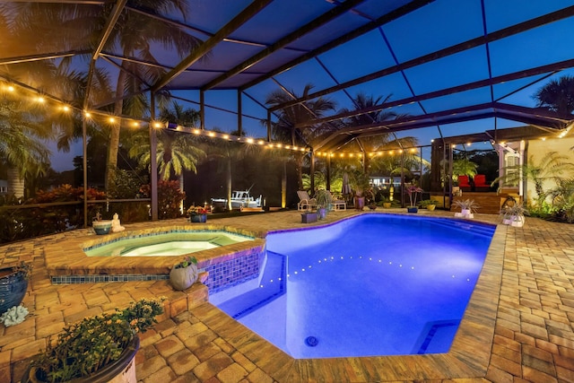 view of pool featuring a lanai, a patio area, and an in ground hot tub