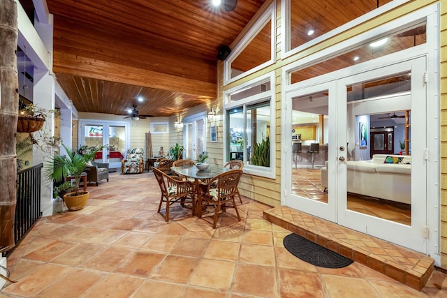 sunroom with ceiling fan, wood ceiling, and french doors