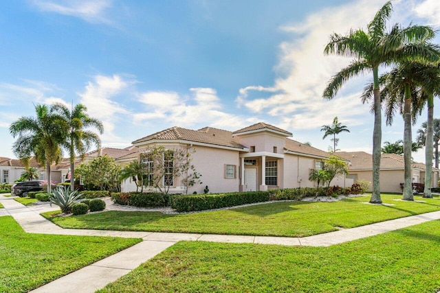 mediterranean / spanish house with a front yard