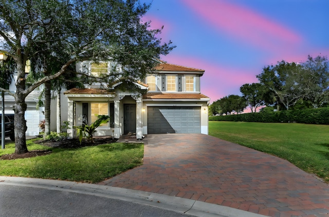 view of front facade featuring a lawn and a garage