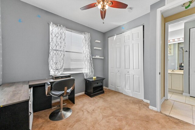 office space featuring ceiling fan and light carpet