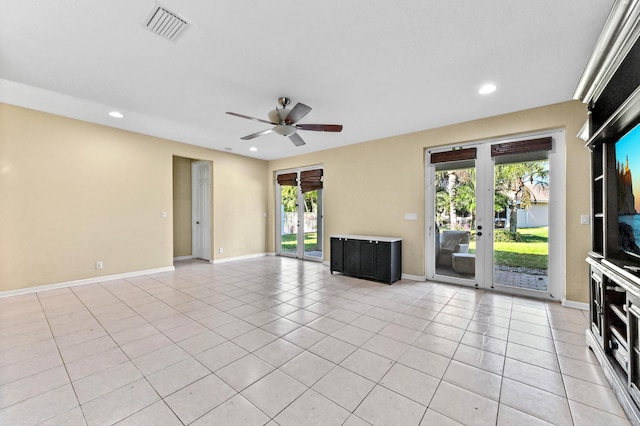 unfurnished living room featuring ceiling fan, light tile patterned floors, and french doors