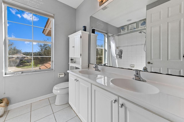 bathroom with tile patterned flooring, vanity, a shower with shower curtain, and a wealth of natural light